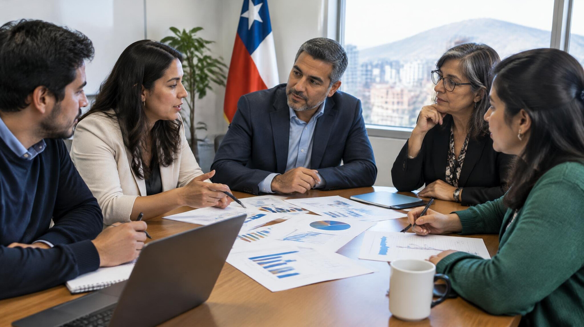 Diverse group of people discussing charts around a table
